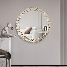 a mirror that is on the wall next to a chair and table in a room