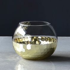 a glass bowl filled with gold colored rocks