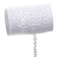 a roll of white paper with beads hanging from it