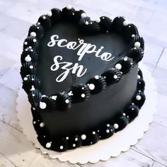 a heart shaped cake with the words scoppie sn on it's side