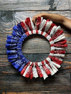 an american flag wreath made out of candy bar wrappers on top of a wooden table