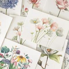 many different colored flowers on white cards