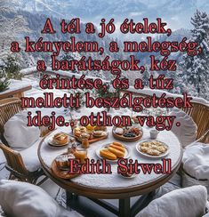 an image of a table with food on it in front of snow covered mountains and trees