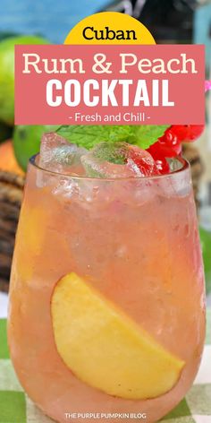 a close up of a drink in a glass on a table with fruit and ice