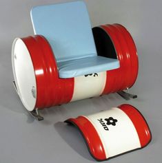 a red and white chair sitting next to a blue chair on top of a gray floor