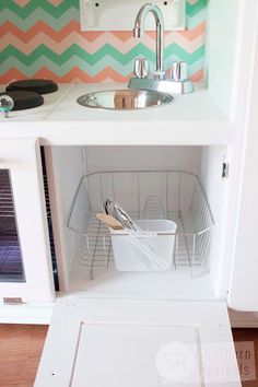 a small kitchen with a sink, stove and microwave