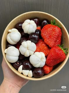 a bowl filled with fruit and vegetables on top of a table