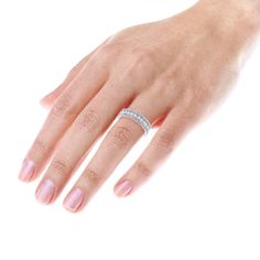 a woman's hand with a diamond ring on it