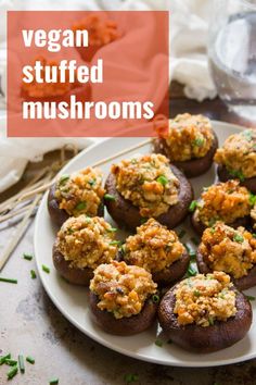 a white plate topped with stuffed mushrooms on top of a table