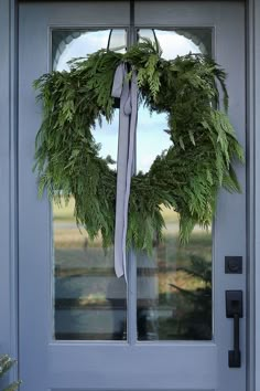 a wreath is hanging on the front door