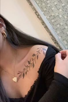 a woman with a tattoo on her shoulder