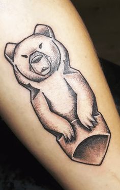 a black and white drawing of a bear on the leg