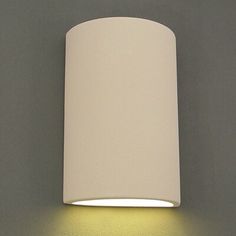 a wall light with a white shade on it