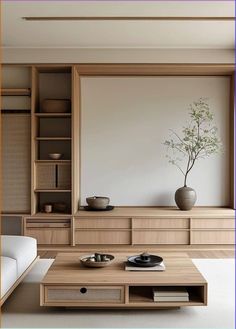 a living room filled with furniture and a vase on top of a wooden coffee table