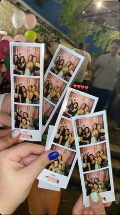 several polaroid photos being held up in front of a group of people at a party