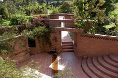 an outdoor area with steps and plants growing on the walls