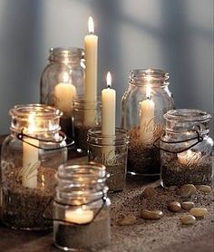 a table topped with mason jars filled with candles