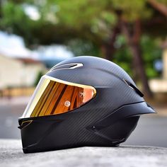 a motorcycle helmet sitting on the side of a road