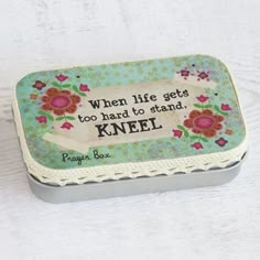 a tin with a quote on it sitting on a table