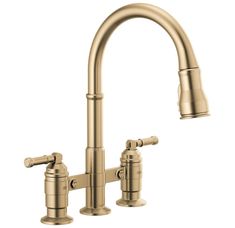 a kitchen faucet with two handles and nozzles