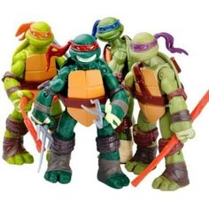 teenage mutant ninja action figures are lined up in a row with one holding two swords