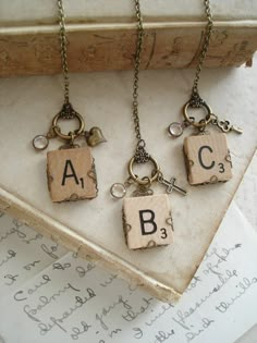 four key chains with letters and charms hanging from them