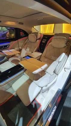 the interior of a car with several seats and electronic devices on display in front of it