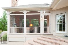 a screened porch with stairs leading up to it