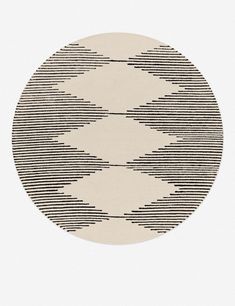 a round rug with black and white lines on it