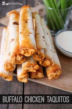 buffalo chicken taquitos on a cutting board with ranch dressing