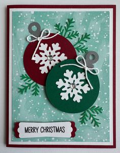 a christmas card with two ornaments on it