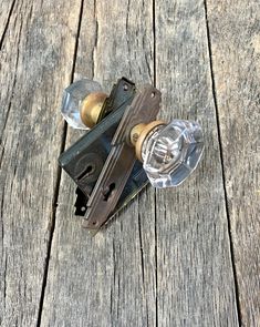 an old style door handle with two knobs on top of wooden planked floor