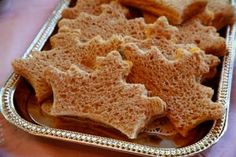 some crackers are in a silver tray on a table