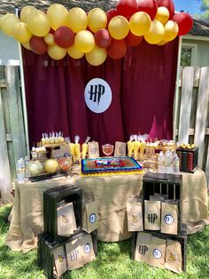 a table topped with lots of food and balloons