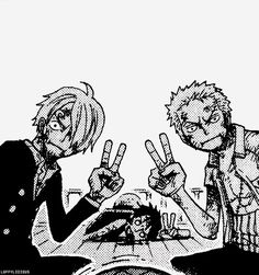 two people sitting at a table making peace signs