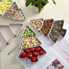 a table topped with bowls filled with different types of fruits and veggies next to a book