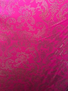 pink and gold fabric with intricate designs on it