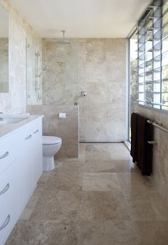 a large bathroom with two sinks and a toilet