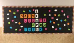 a bulletin board that says solve create grow think on the wall in a room with tile flooring