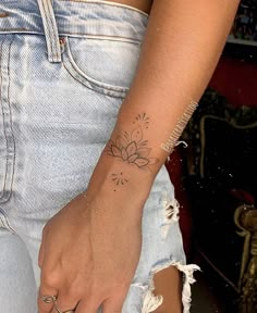 a woman's arm with a flower tattoo on it