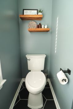 a white toilet sitting inside of a bathroom