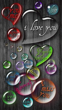 the words i love you are written in different colors and shapes on a wooden background