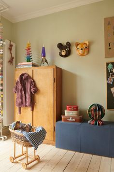 a child's room with toys and decor on the wall, including a toy crib