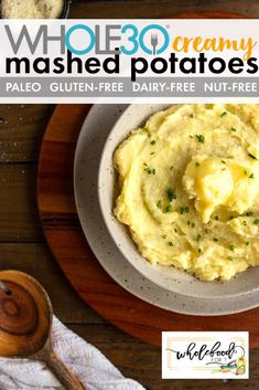 a bowl filled with mashed potatoes on top of a wooden table