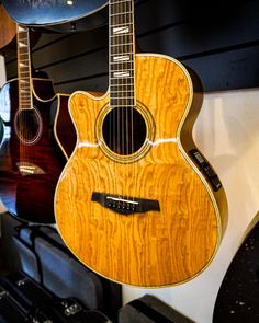 guitars are lined up on display in a music store