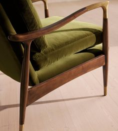 a green chair sitting on top of a hard wood floor