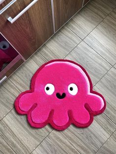 a pink rug with an octopus on it