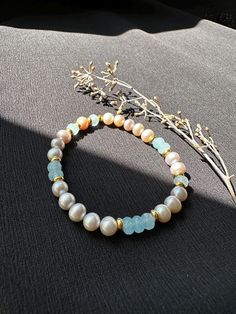 This pearl bracelet has your 'something blue' for a bride-to-be but would be adored by anybody... including YOU!! Aquamarine can be used to help calm the mind and nerves. A wee little help for the big day to settle any possible jitters. You've got this! Details:  Dainty bracelet you can wear everyday or on a special occasion.  Freshwater potato pearls, oyster colored, 6mmx4mm Aquamarine faceted rondelles, 6mm Gold plated flat spacers, 5mm Gold plated etched spacer, 4mm Happy to receive a DM to i Blue Pearl, Dainty Bracelets, Wedding Jewelry Bracelets, Something Blue, Pearl Bracelet, Crystals And Gemstones, Big Day, Wedding Jewelry, Gold Plate