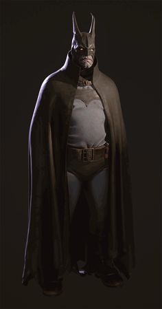 a man dressed as batman standing in the dark with his cape over his head and hands on his hips