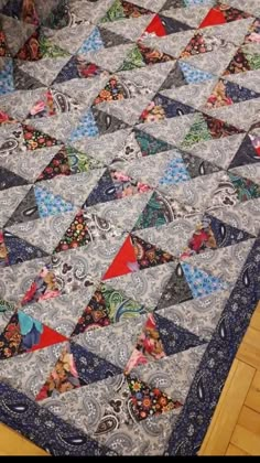 a large quilt is laying on the floor